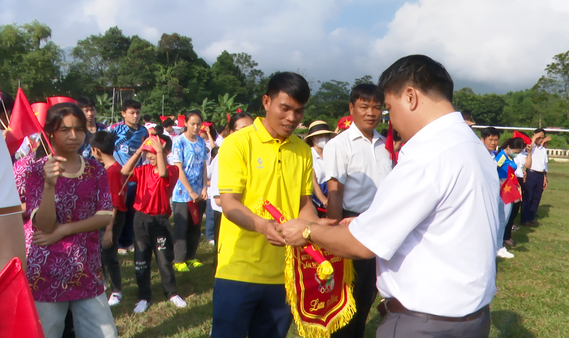Đồng chí Hà Tự Nhiên, Ủy viên Ban Chấp hành Huyện ủy, Trưởng Phòng Giáo dục & Đào tạo trao cờ lưu niệm cho các đoàn tham gia Hội khỏe Phù đổng
